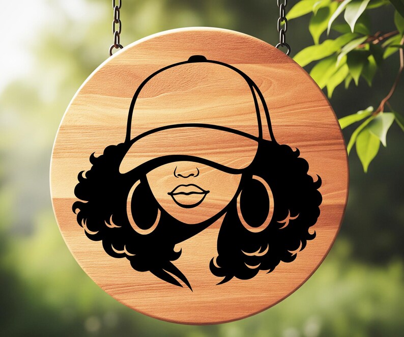 May include: A round wooden sign with a black graphic of a woman wearing a baseball cap and hoop earrings. The sign is hanging from two chains and has a natural wood grain finish.