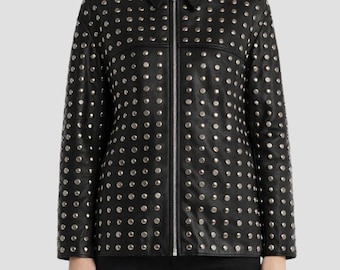 May include: Black leather jacket with silver-colored stud embellishments. The jacket features a collared neckline, a full-length zipper, and long sleeves. The studs are evenly spaced across the jacket's surface, creating a textured appearance. The model is wearing black pants.