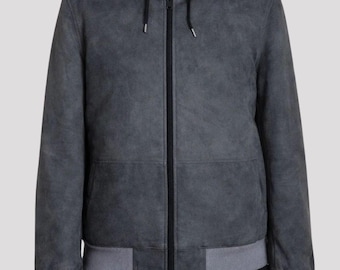 May include: A charcoal gray hooded jacket with a full-length zipper. The jacket features a gray ribbed hem and cuffs. The hood is lined with a darker fabric. The jacket is made of a soft, suede-like material.
