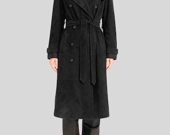 May include: A black double-breasted trench coat with a matching belt. The coat features a classic design with a notched collar, button closures, and long sleeves. The coat is made of a suede-like material and is knee-length.