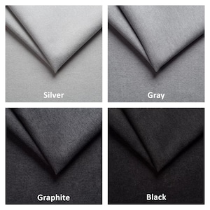 May include: A collection of four fabric swatches in shades of gray and black. The swatches are labeled "Silver", "Gray", "Graphite", and "Black". Each swatch is folded to show the texture and color variations.