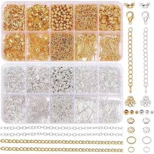 May include: A clear plastic organizer filled with gold and silver jewelry-making supplies. The compartments contain various beads, clasps, jump rings, headpins, and chain. A selection of gold and silver chains and jewelry findings are displayed.