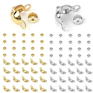 May include: A selection of gold and silver jewellery findings, including crimp beads and end caps. The end caps have a curved design with loops, and the crimp beads are small and round. The findings are arranged in rows and columns.