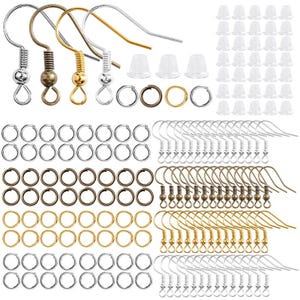 May include: A selection of earring-making components, featuring silver, bronze, and gold-toned earring hooks, jump rings, and clear earring backs. The hooks display diverse designs, and the jump rings are available in various sizes.