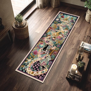 May include: A rectangular rug with a whimsical Alice in Wonderland design. The rug features a light blue background with illustrations of clocks, teacups, and characters. The border is a dark purple with a white trim.