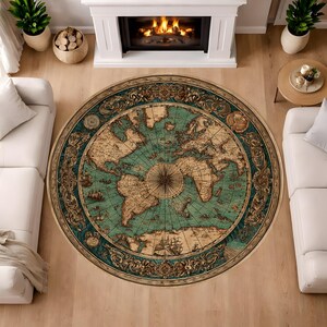 May include: Round area rug featuring a vintage world map design. The rug has a teal and beige color scheme with intricate details of continents, oceans, and sailing ships. The rug is placed on a wooden floor.
