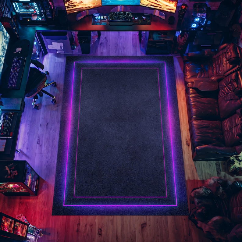 May include: Overhead view of a gaming setup with a large black rug featuring a glowing purple border. The room includes multiple computer monitors, keyboards, and a leather sofa. The lighting is a mix of purple and red.