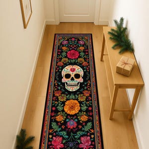May include: A long, rectangular black rug featuring a colorful Day of the Dead skull design. The rug is adorned with vibrant floral patterns in shades of pink, orange, yellow, and green, creating a festive and decorative accent for a hallway or entryway.