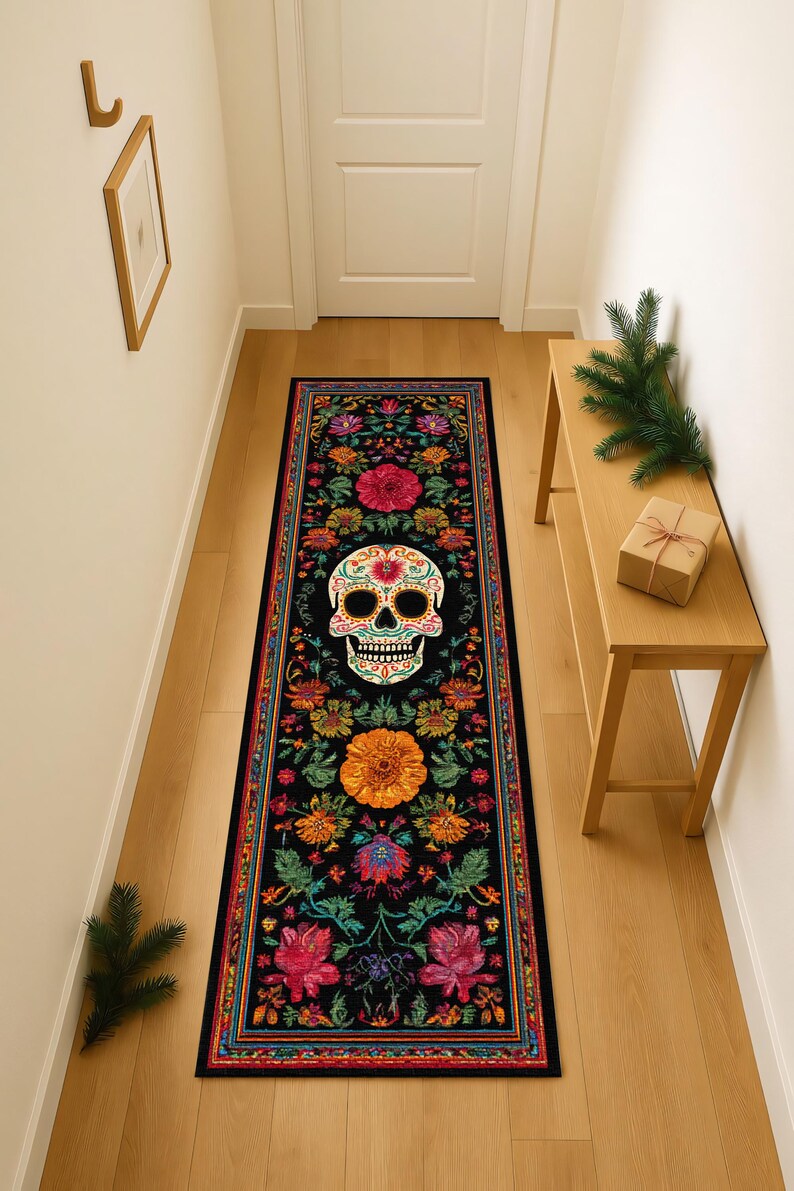 May include: A long, rectangular black rug featuring a colorful Day of the Dead skull design. The rug is adorned with vibrant floral patterns in shades of pink, orange, yellow, and green, creating a festive and decorative accent for a hallway or entryway.