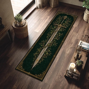 May include: A rectangular runner rug featuring a deep forest green background with a central metallic sword graphic entwined with golden vine and leaf illustrations. The rug is bordered by a thin gold frame with ornate corner scrollwork details.