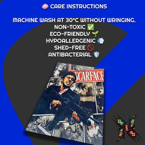 May include: A rectangular, dark-colored textile featuring a graphic from the movie "Scarface" with Al Pacino. The image includes text: "CARE INSTRUCTIONS", "MACHINE WASH AT 30&deg;C WITHOUT WRINGING", "NON-TOXIC", "ECO-FRIENDLY", "HYPOALLERGENIC", "SHED-FREE", and "ANTIBACTERIAL".