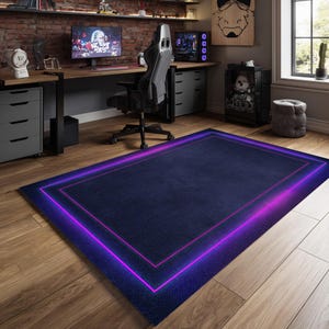 May include: A rectangular navy blue rug with a glowing neon purple and pink border. The rug is placed on a wooden floor in a room with a computer desk, chair, and monitor. The rug's dimensions are approximately 60 inches by 80 inches.