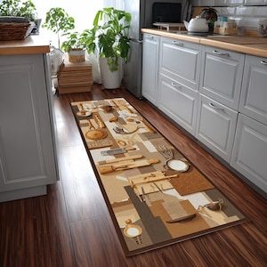 May include: A rectangular kitchen rug with a brown border and a beige, brown, and tan pattern. The pattern features various kitchen utensils, including knives, cutting boards, and whisks. The rug is placed on a dark wood floor in front of a kitchen counter.