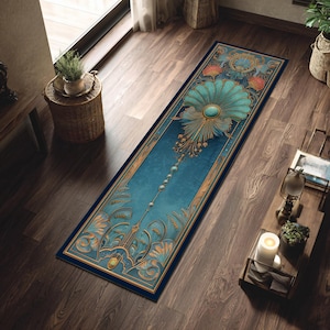 May include: An Art Deco-inspired rug with a teal and gold floral pattern on a dark blue base. The rug's design includes a central stylized flower and decorative borders. It is placed on a wooden floor, adding a touch of elegance. The rug measures approximately 200 cm in length.