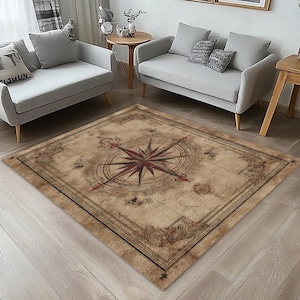 May include: A rectangular rug with a vintage map design. The rug features a large compass rose in the centre, with a dark red starburst design. The rug's border has a decorative floral pattern and a dark brown frame.