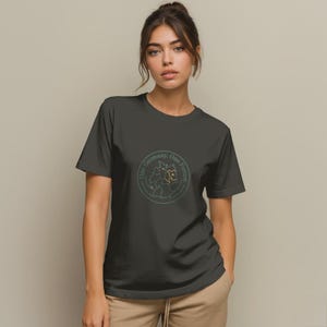 May include: Dark gray t-shirt featuring a circular graphic with a map of Germany and the text "One Germany, One Future" in a green and orange color scheme. The shirt is made of a soft material.