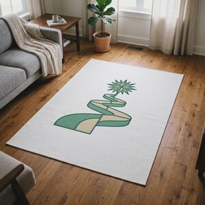 May include: A rectangular area rug featuring a white background with a central graphic design. The design consists of a stylized, winding ribbon in shades of teal and light beige, topped with a multi-pointed teal star at the very peak.