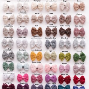 May include: A color chart featuring 59 yarn samples in various shades, including white, beige, pink, and blue. Each sample is a small bow with a label indicating the color name, such as "White," "Pink," and "Black." The chart is designed to showcase the range of available colors.