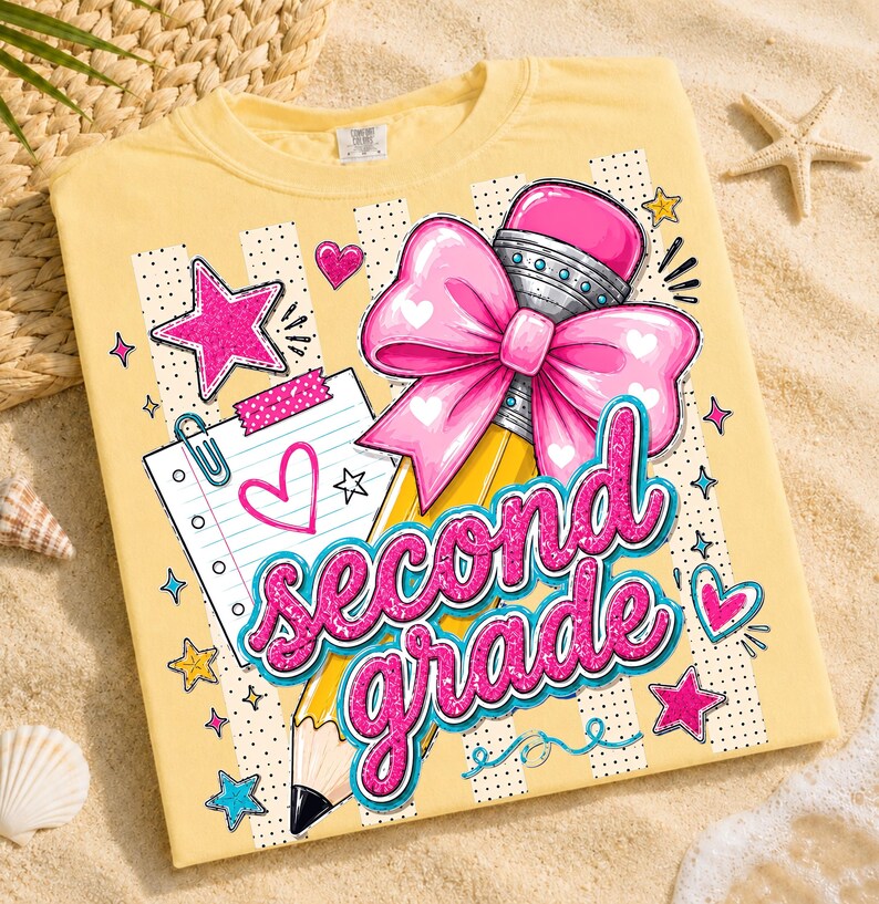May include: A pale yellow t-shirt featuring a graphic print of a yellow pencil with a large pink bow, a piece of lined notebook paper with a heart, and the text second grade in glittery pink letters, surrounded by stars and small hearts.