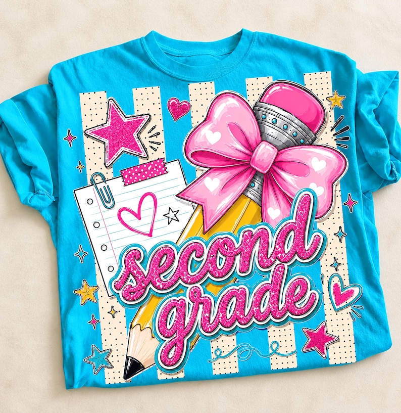 May include: A bright turquoise t-shirt featuring a graphic print of a yellow pencil with a large pink bow, a lined notepad with a paperclip, and the text "second grade" in glittery pink script, surrounded by pink and yellow stars and hearts.