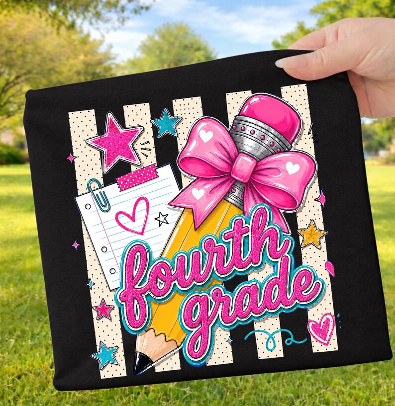 May include: A black fabric item featuring a graphic design of a yellow pencil with a large pink bow, a piece of lined notebook paper with a pink heart, and the text "fourth grade" in pink glittery script, surrounded by pink, blue, and yellow stars.
