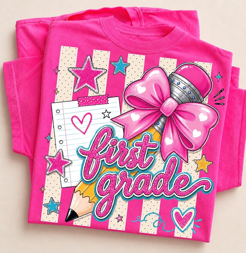 May include: A bright pink t-shirt featuring a graphic print of a yellow pencil with a large pink bow, a piece of lined notebook paper with a heart, and the text "first grade" in glittery pink script. The design includes pink and blue stars.