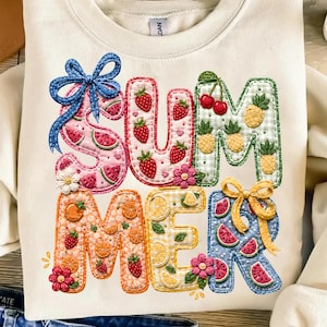 May include: Cream-colored sweatshirt with the word "SUMMER" in colorful, embroidered letters. The letters are decorated with watermelon, strawberries, cherries, oranges, lemons, and pineapples. A blue bow accents the "S" and a yellow bow accents the "R".