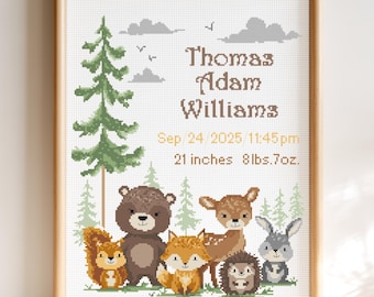 May include: A framed cross-stitch pattern featuring a forest scene with a tall pine tree, gray clouds, and woodland animals including a squirrel, bear, fox, deer, hedgehog, and rabbit. Text reads Thomas Adam Williams, Sep 24 2025 11:45pm, 21 inches 8lbs.7oz.