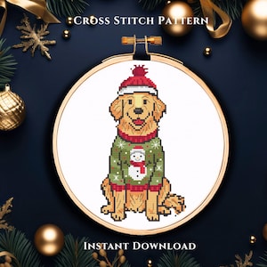 May include: Cross-stitch pattern featuring a golden retriever wearing a red hat and a green sweater with a snowman design. The design is set in a wooden embroidery hoop. The text "Cross Stitch Pattern" and "Instant Download" are visible.