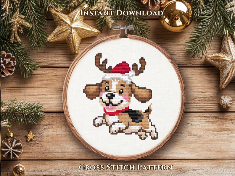 May include: A cross stitch pattern in a wooden embroidery hoop featuring a cartoon beagle dog wearing a red and white Santa hat with reindeer antlers, a red collar, and a black and brown coat, set against a white fabric background.