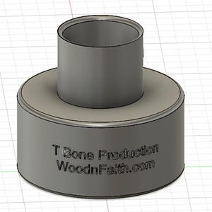 May include: A cylindrical, gray object with a smaller cylinder on top. The base has a wider diameter than the top cylinder. The text "T Bone Production WoodnFaith.com" is printed on the side of the base.