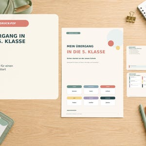 May include: A printable PDF document titled "Übergang in die 5. Klasse" with 30 pages, featuring a main page with educational text, colourful rectangular boxes, and smaller cards, all displayed on a light wood surface with pens and a notebook.
