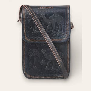 The Nagaur Sling in Dark Olive, hand-embossed leather mobile sling, front view