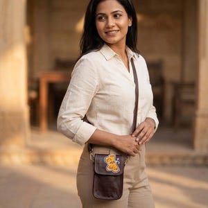 The Nagaur Kashidakari Sling worn cross-body at the hip in warm afternoon light (AI-generated)