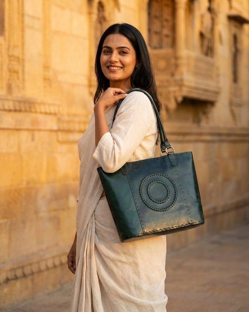 A woman carries The Rambagh Tote over one shoulder in Rajasthan's golden evening light (AI-generated)