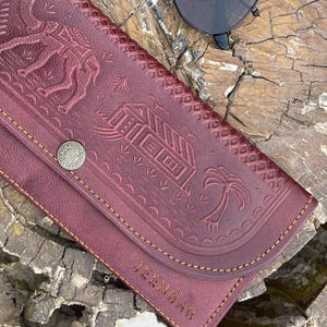 The Gangaur Clutch in Cherry, full-grain leather, handcrafted by artisan Mohan