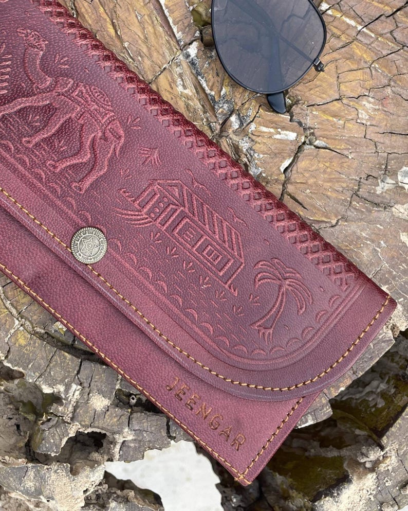 The Gangaur Clutch in Cherry, full-grain leather, handcrafted by artisan Mohan