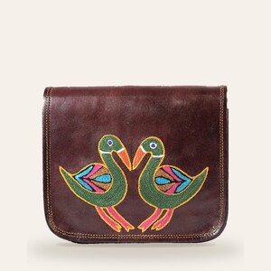 The Moruda Sling, two birds hand-embroidered in Kashidakari on cherry-brown full-grain leather, front view