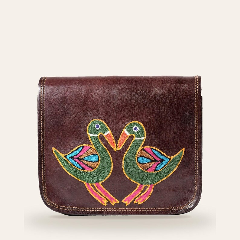 The Moruda Sling, two birds hand-embroidered in Kashidakari on cherry-brown full-grain leather, front view