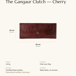 Specification card for The Gangaur Clutch in cherry: 8 inches wide, 4 inches high, full-grain leather, babul bark tannage. Made by Mohan.
