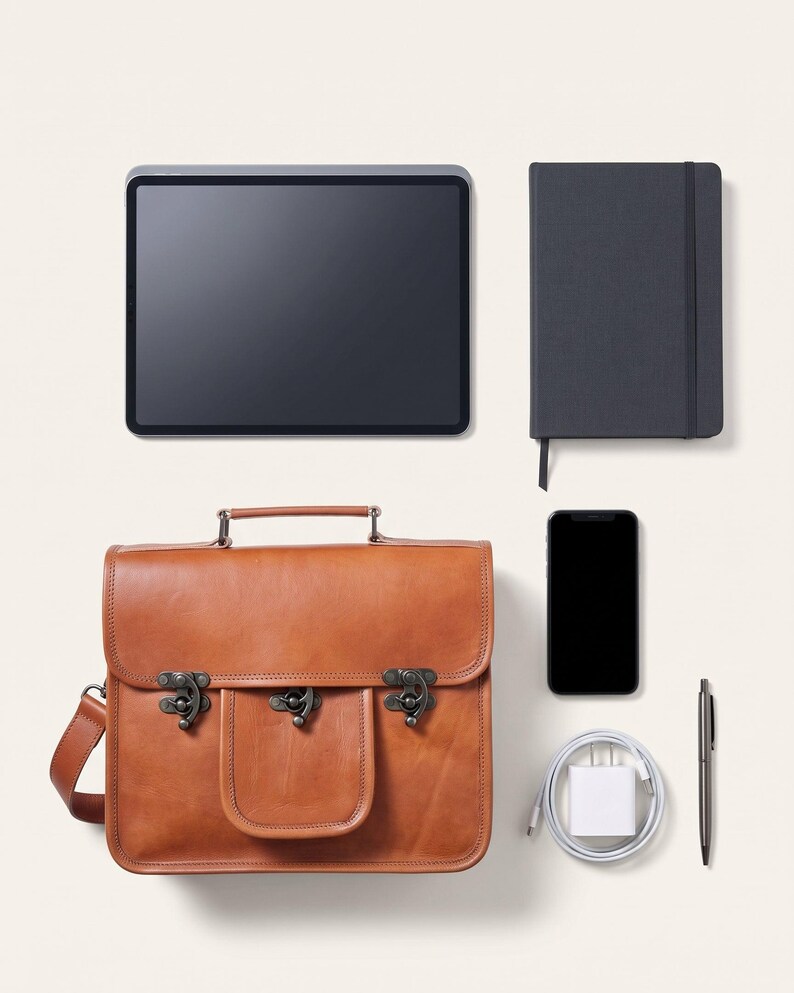 The Malani Messenger shown with an 11-inch tablet, A5 journal, phone, charger and pen to show what it holds (AI-generated)