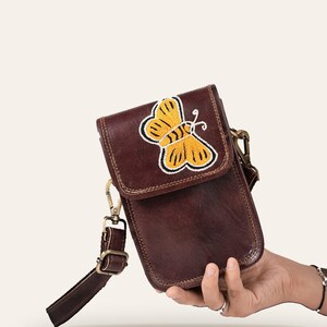The Nagaur Kashidakari Sling held in one hand, showing its compact phone-sized scale