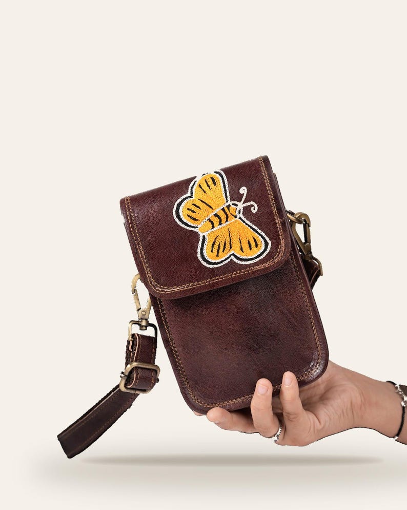 The Nagaur Kashidakari Sling held in one hand, showing its compact phone-sized scale