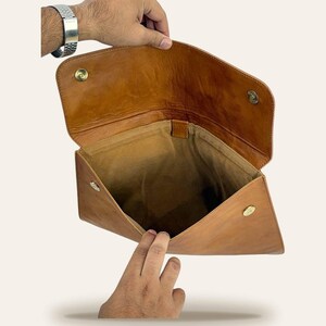 The Barmer Tech Sleeve held open to show the soft suede-lined interior and brass magnetic snaps