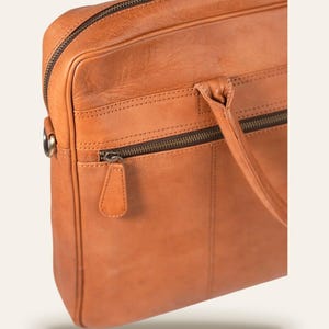 The Sonar Briefcase, three-quarter view showing the full-width front zip pocket