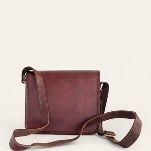 The Jaisalmer Sling in Cherry, back view with the leather strap and brass buckle adjuster