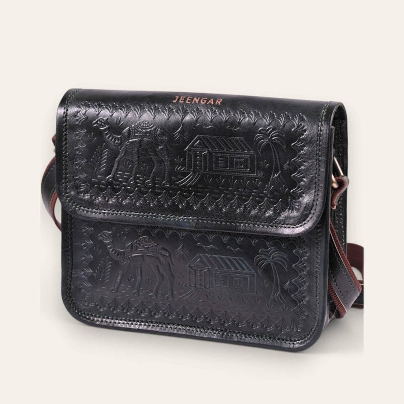 The Pushkar Sling in Dark Olive, hand-embossed camel motif on real leather, front view
