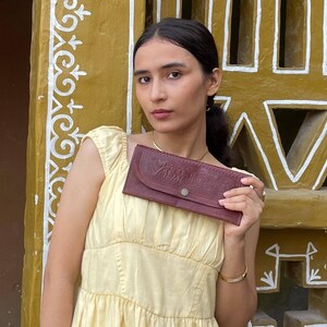 The Gangaur Clutch in Cherry, embossed camel and palm motif on real leather