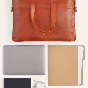 What fits inside The Mehrangarh Briefcase: a 15-inch laptop, document folder, notebook and charger (AI-generated)