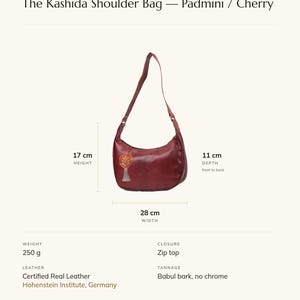 Specification card for The Kashida Shoulder Bag (Padmini / Cherry): 28 cm wide, 17 cm high, full-grain leather, babul bark tannage. Made by Ravi.